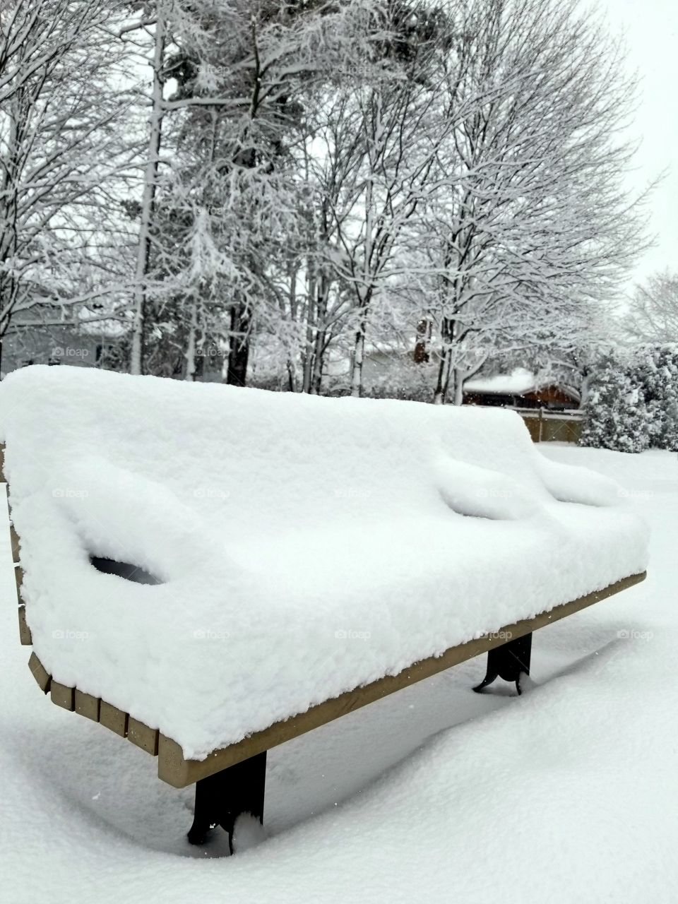 Park bench after a snowfall