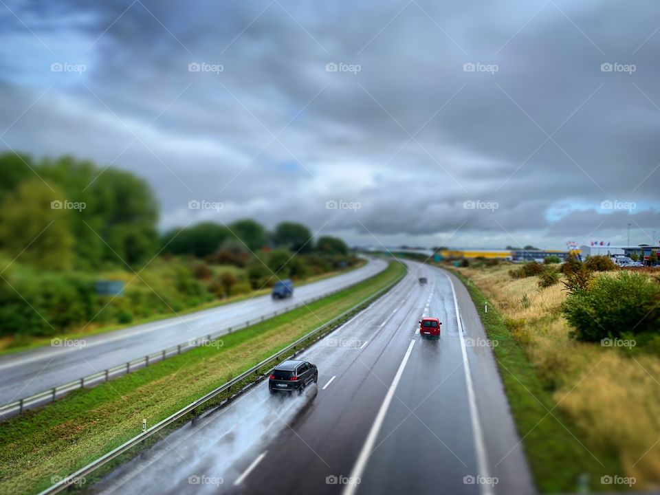 A car drivong fast on a wet highway