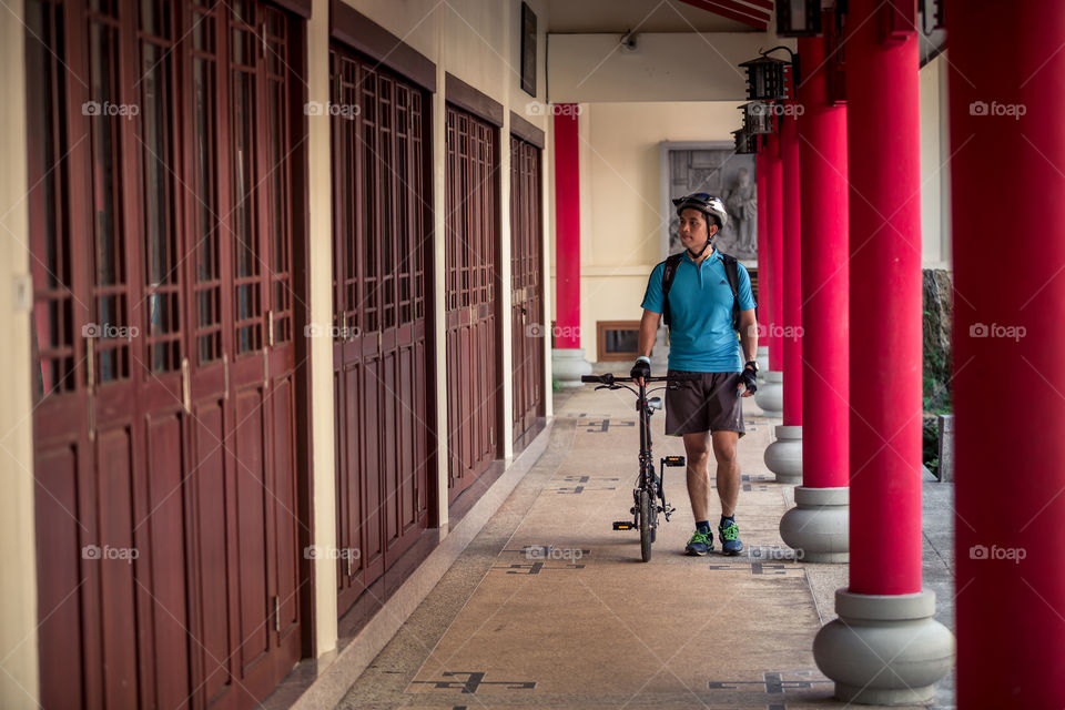 Man with bike inside the Chinese temple