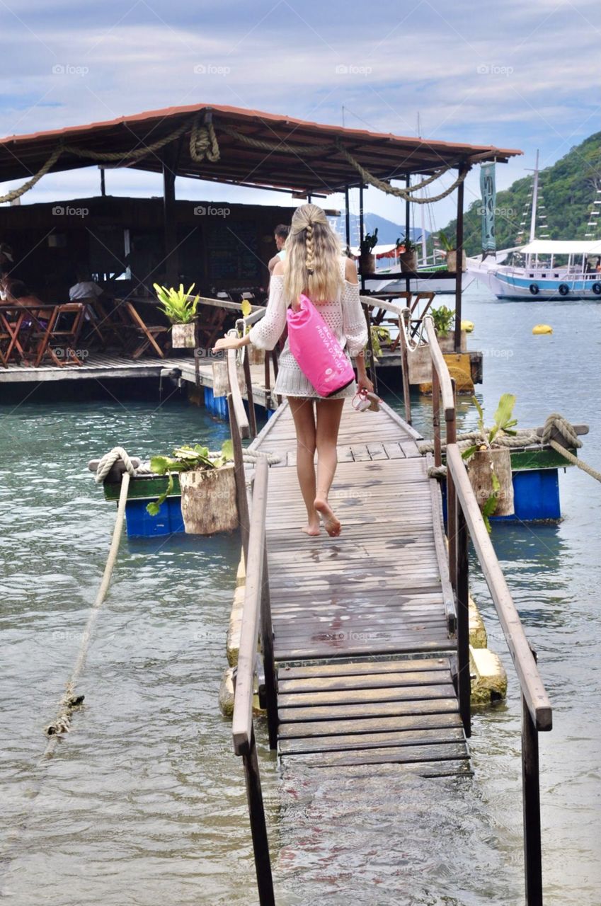 Woman walking on wooden deck