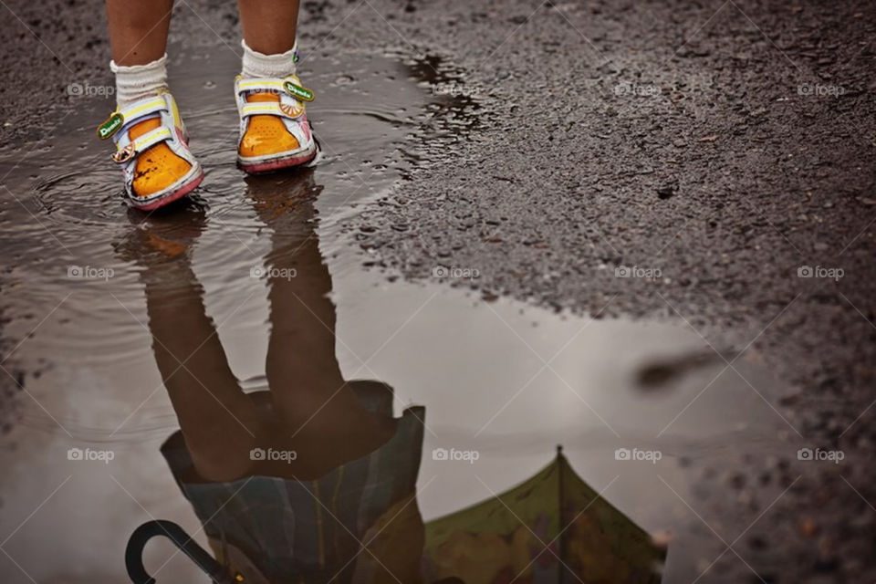 Girl standing in puddle