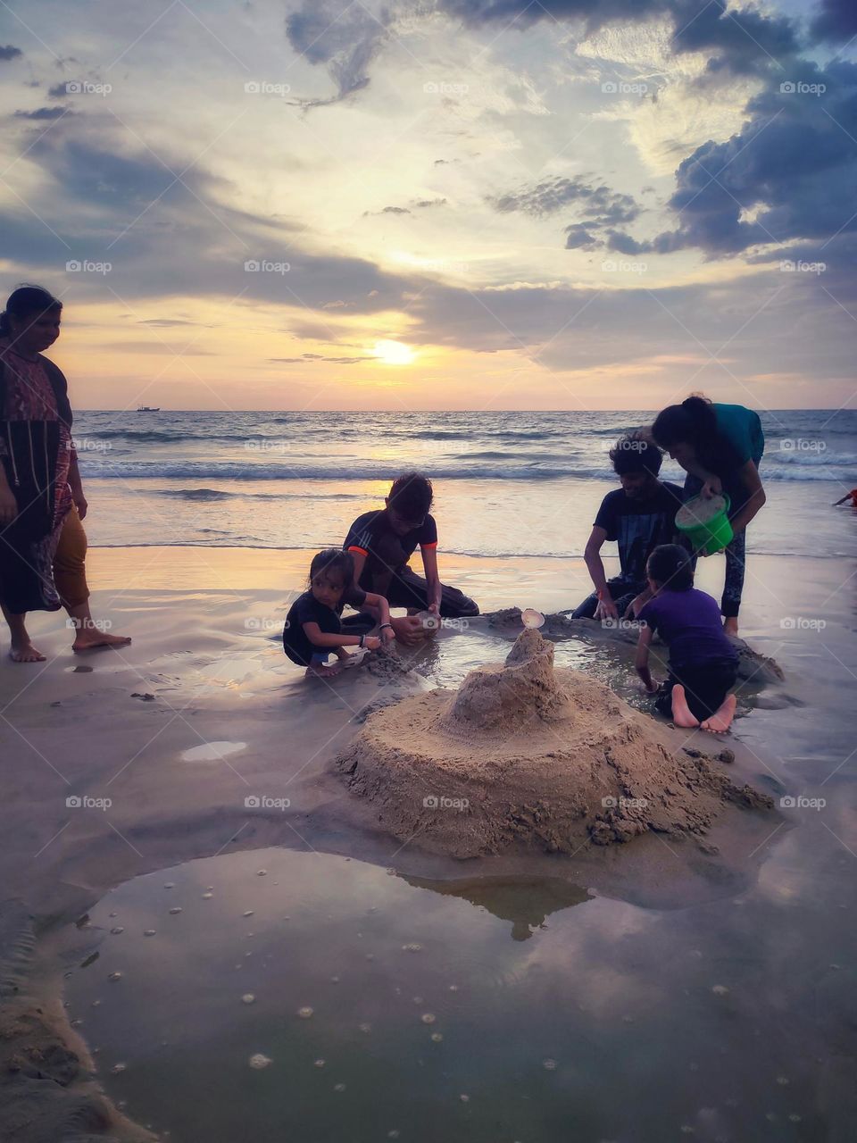 playing in the beach with friends during sunset