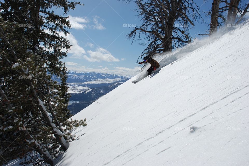 A person skiing on snowy mountain