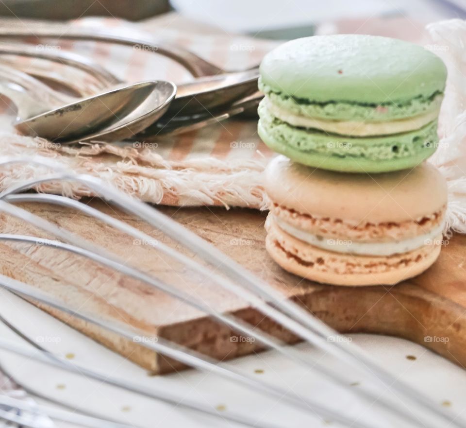 Macaroons and utensils on cutting board