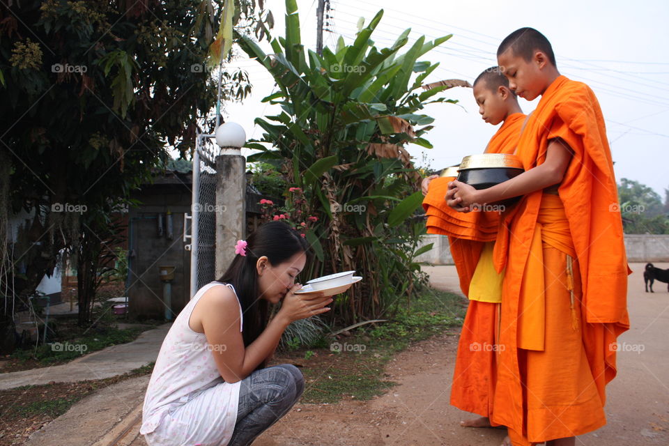 Giving food to the monk, north of Thailand.