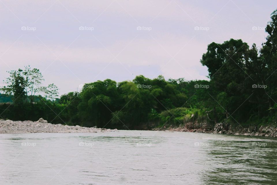 the river water flows so calmly there are no rocks in its path this is deep water so that you can only see the water flowing quietly