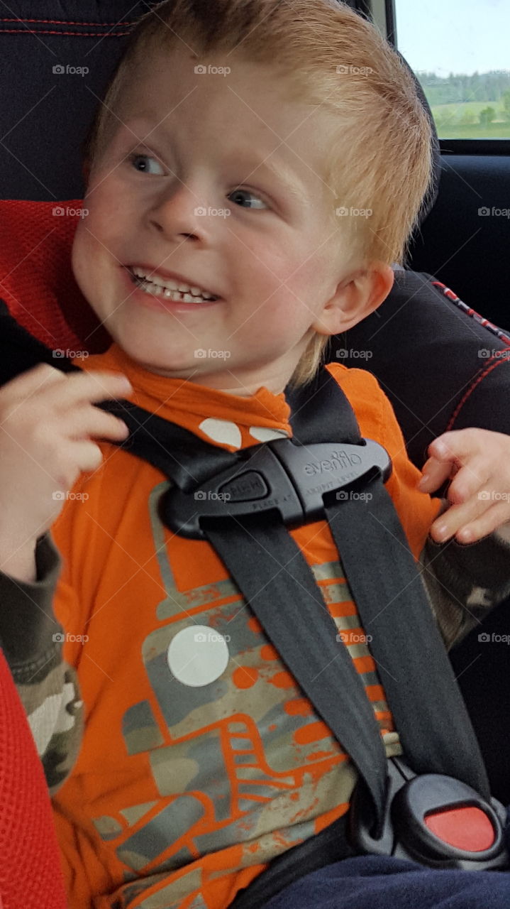 Happy child in car seat