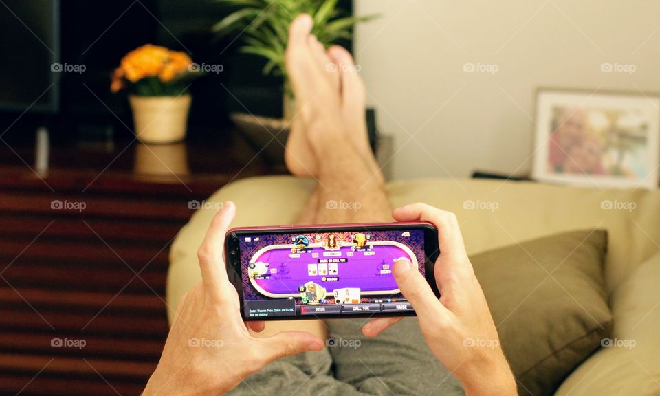 Boy playing video game on cell phone