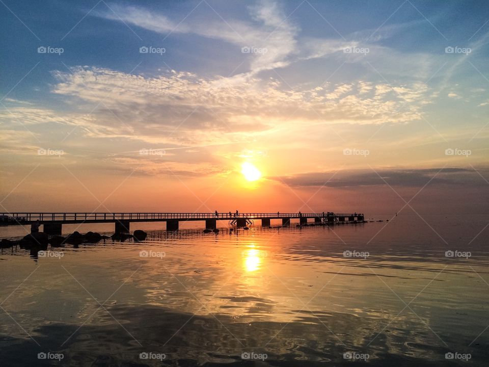 Silhouette of bridge over the lake during sunset