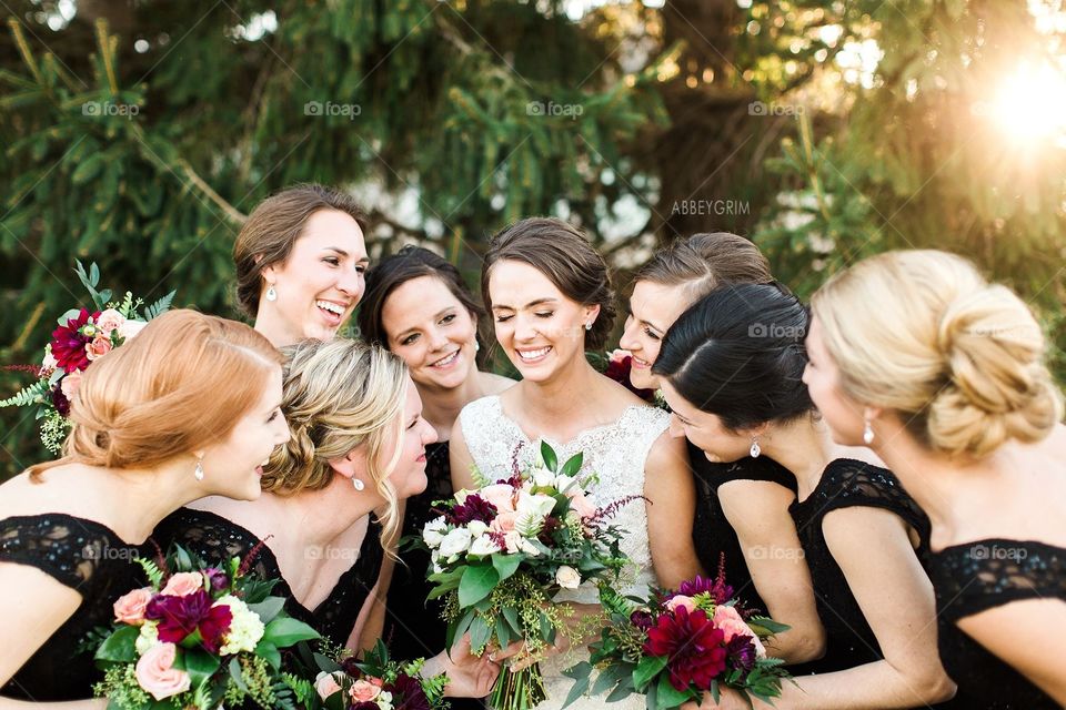 Bride laughing with her bridesmaids 
