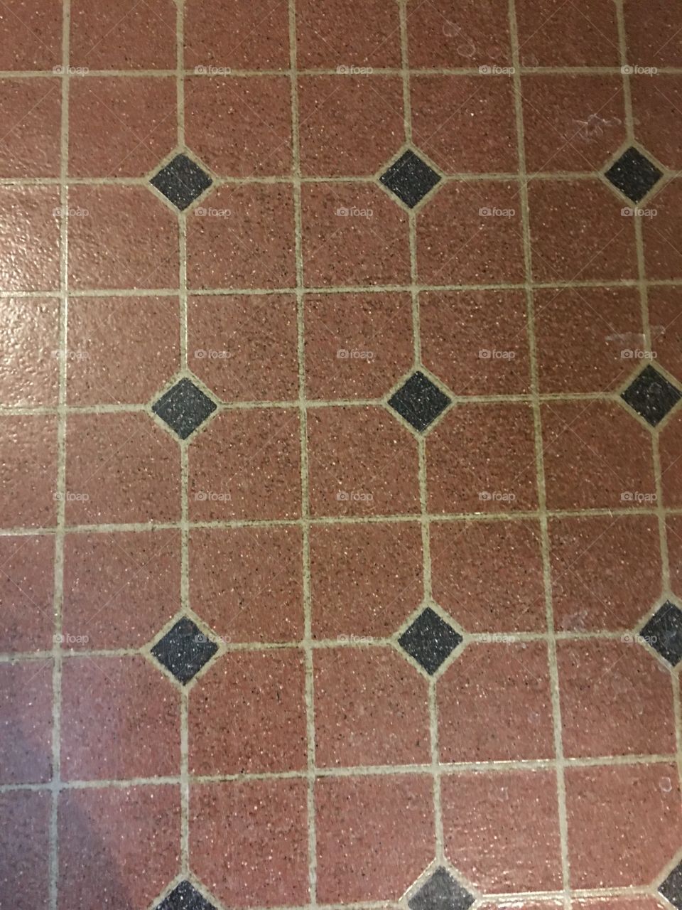 Brown floor print, could be tile.