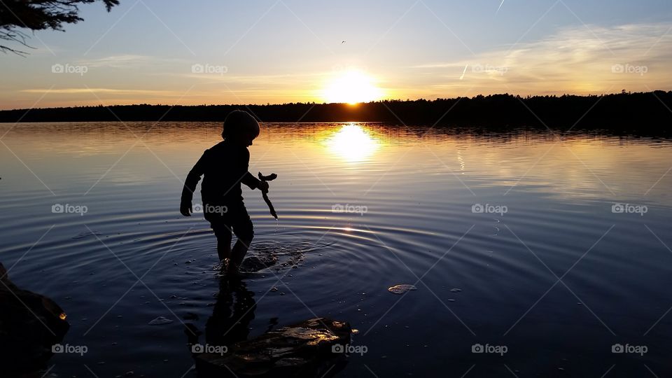 sillohette of child in water
