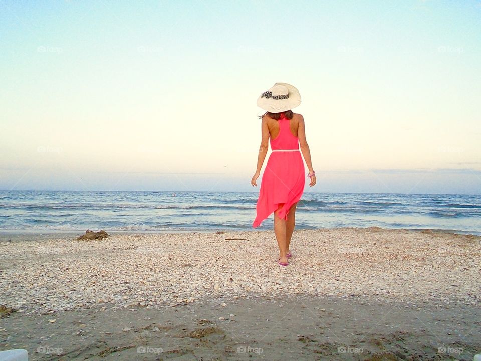 Rear view of woman walking on beach