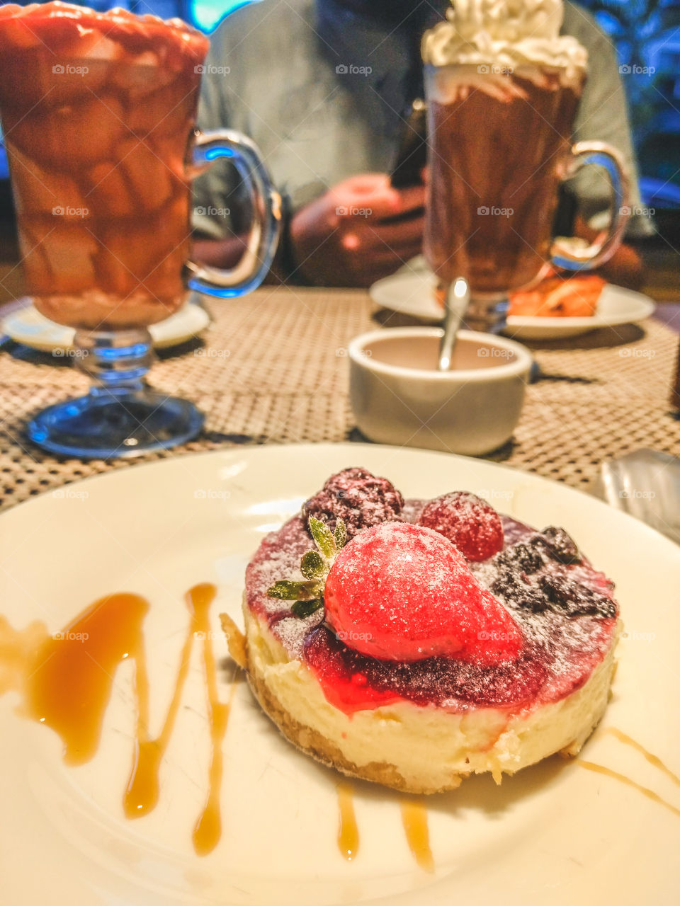 Drinking coffee and eating a cheesecake