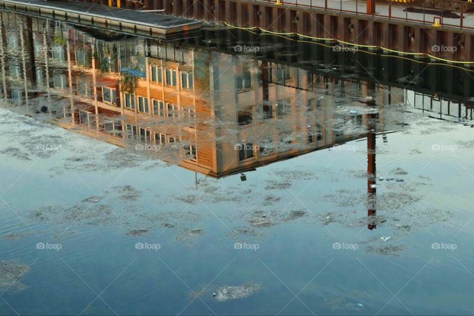 Reflection of a building in a river at sunset