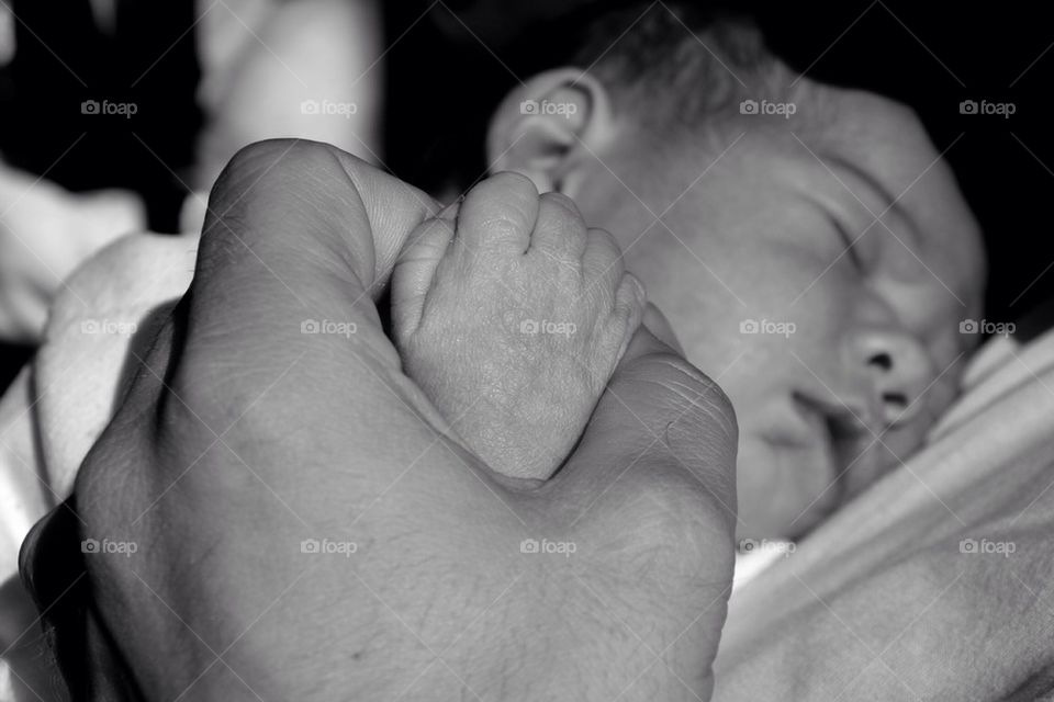 Holding hands with dad. Small and big together