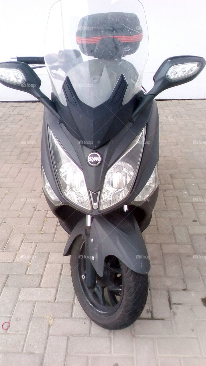 Sym motorcycle in street