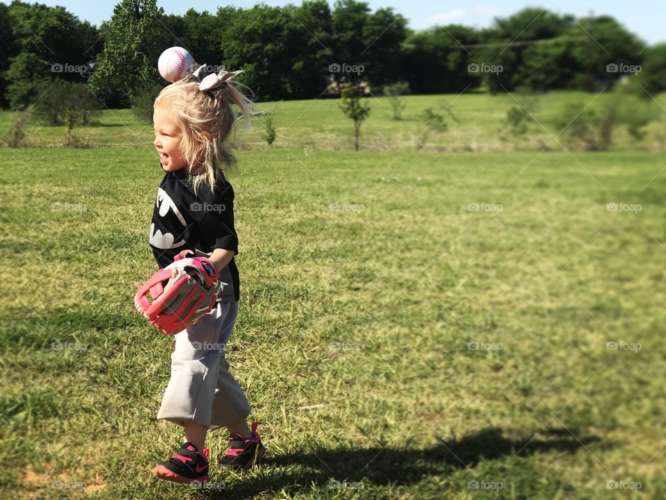 Toddler girl throwing a ball