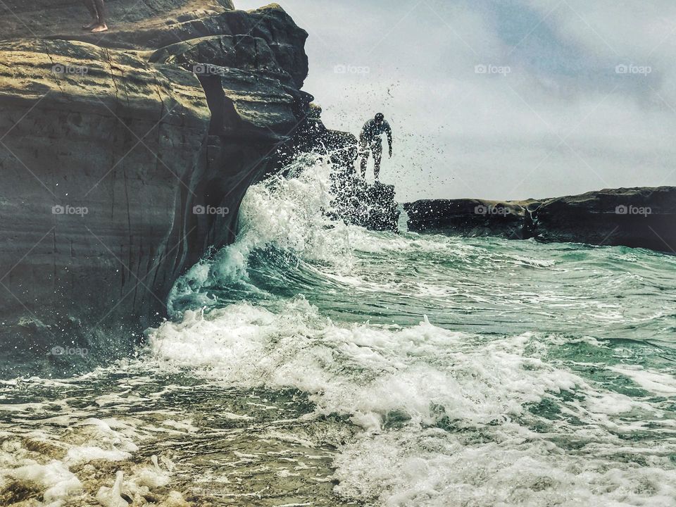 jumping into the waves at Torrey Pines in San Diego