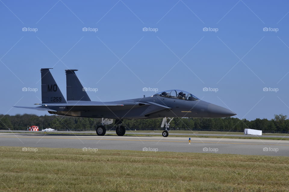 A USAF F-15E Strike Eagle taxis before taking off and performing some maneuvers and a supersonic flyby.