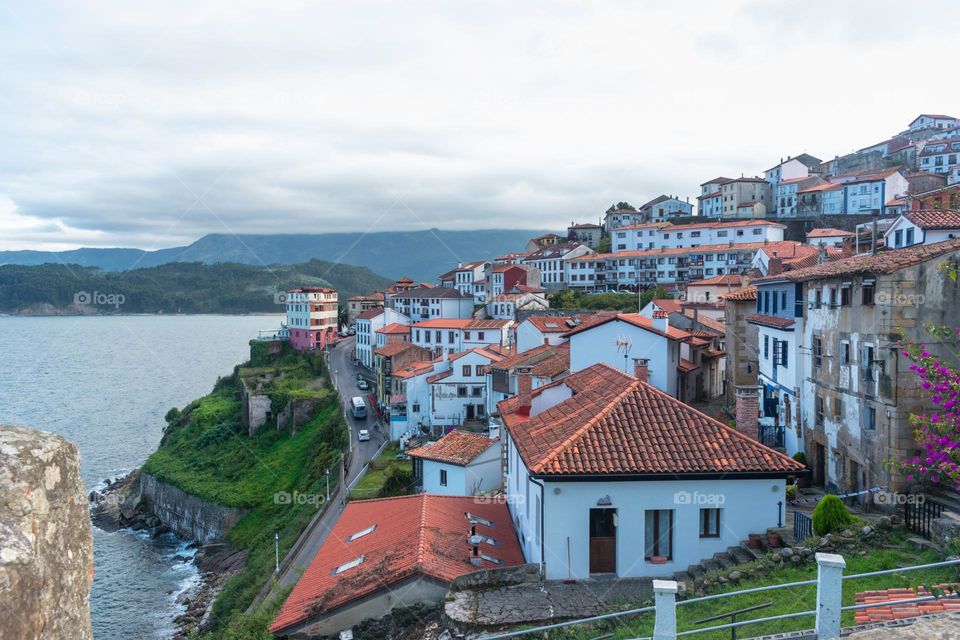 Panoramic view of the village of Lastres (Asturias) with the Cantabrian Sea, landscape and mountains. Lastres, Asturias, Spain.