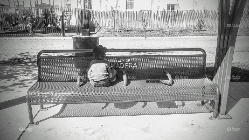 Lonely kid on the bus stop