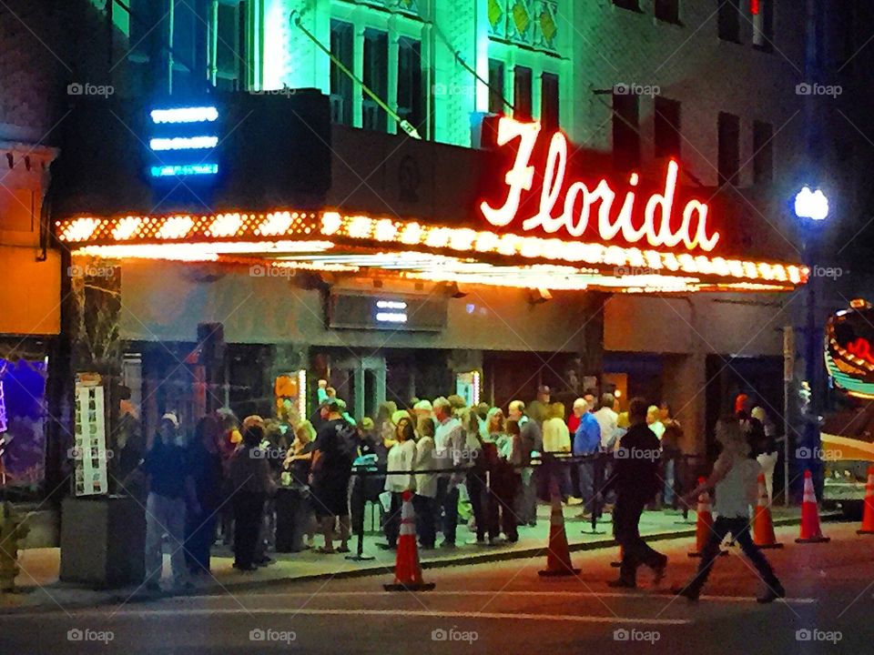 People lined up under neon lights for a concert at the historic Florida Theatre in Jacksonville 