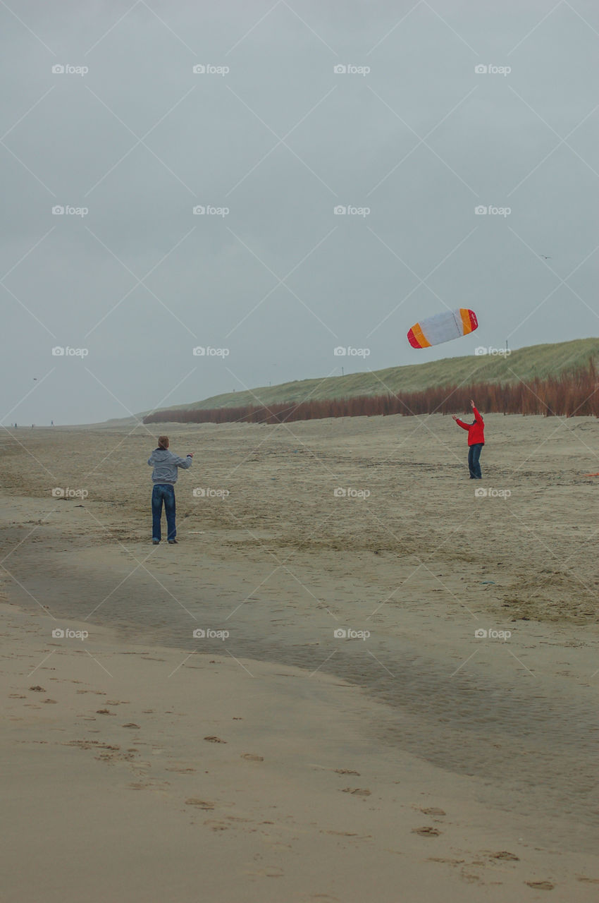 Playing With A Kite At The Beach