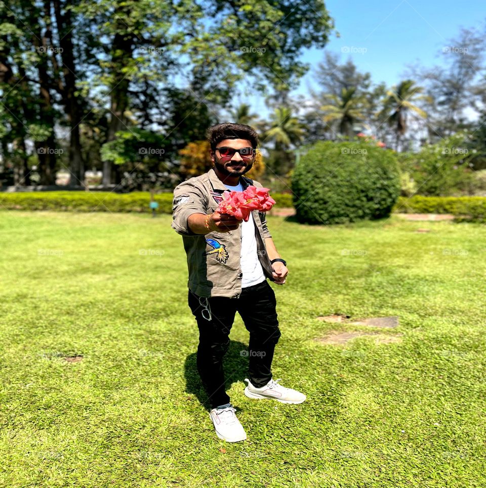 Handsome boy give a flower for all looks nice garden place so clean and peaceful place