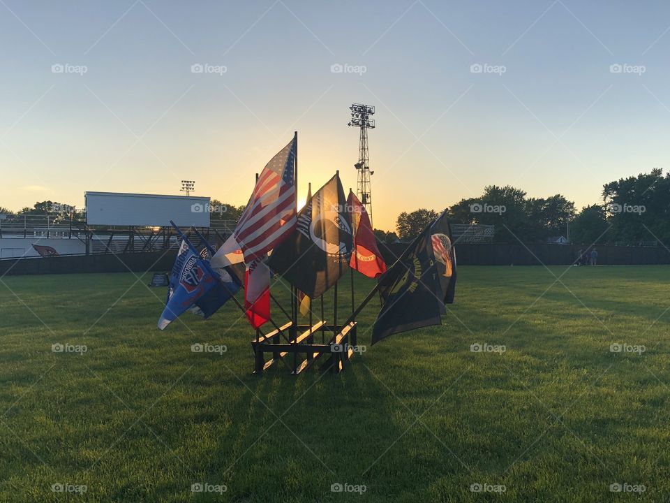 A photo of various flags dating to Vietnam in front of The Wall That Heals, a traveling dedicated memorial to soldiers of the Vietnam era. 