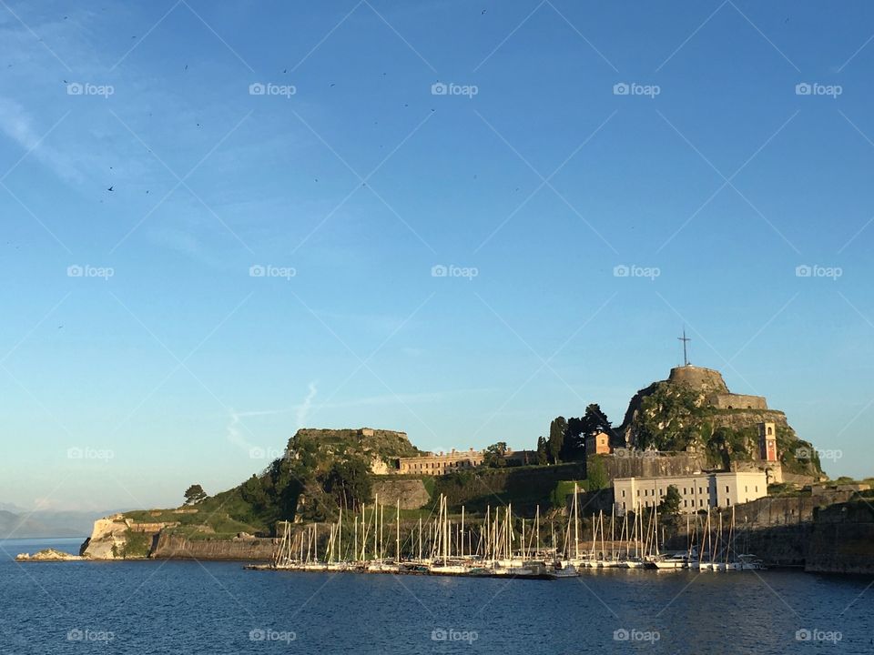 Birds fly away from the Old Fortress across the sea, Corfu Town, Greece