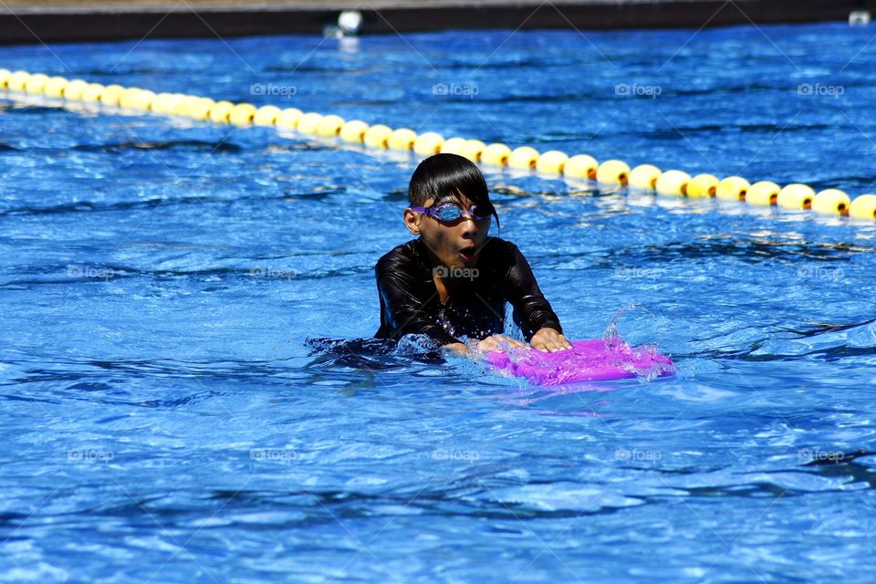 teenager swimming in a pool