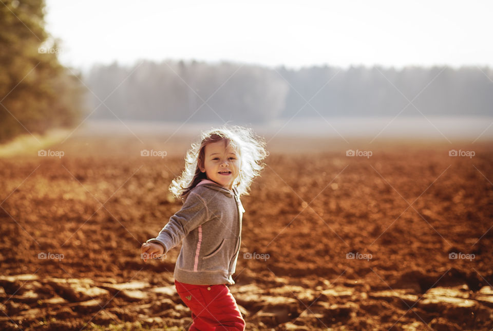 Little girl runs on nature 