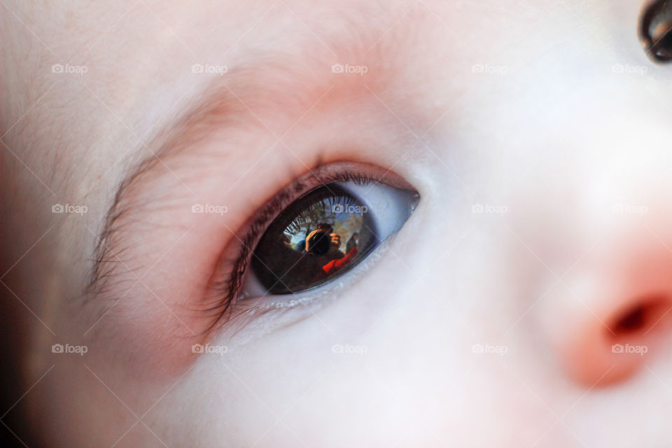 Reflection of photographer in baby's eye