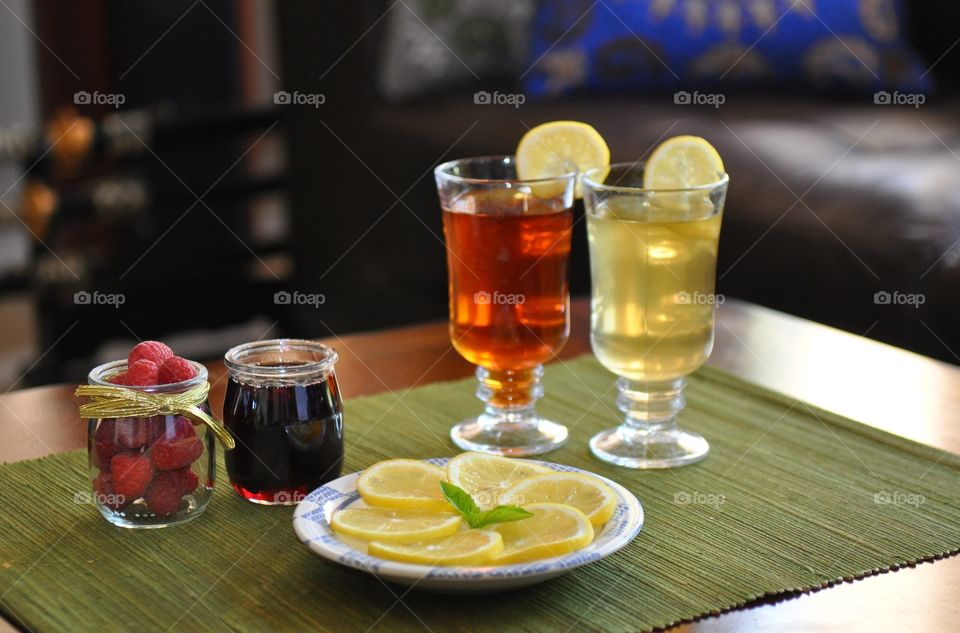 Healthy drink served with lemon slices and berry fruit