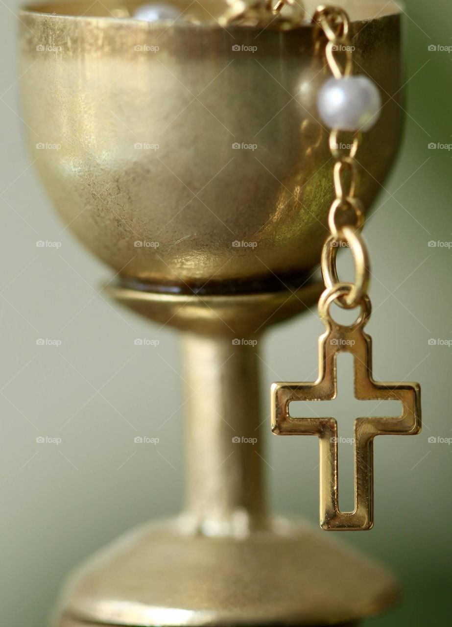 Close-up of a mini chalice with a crucifix