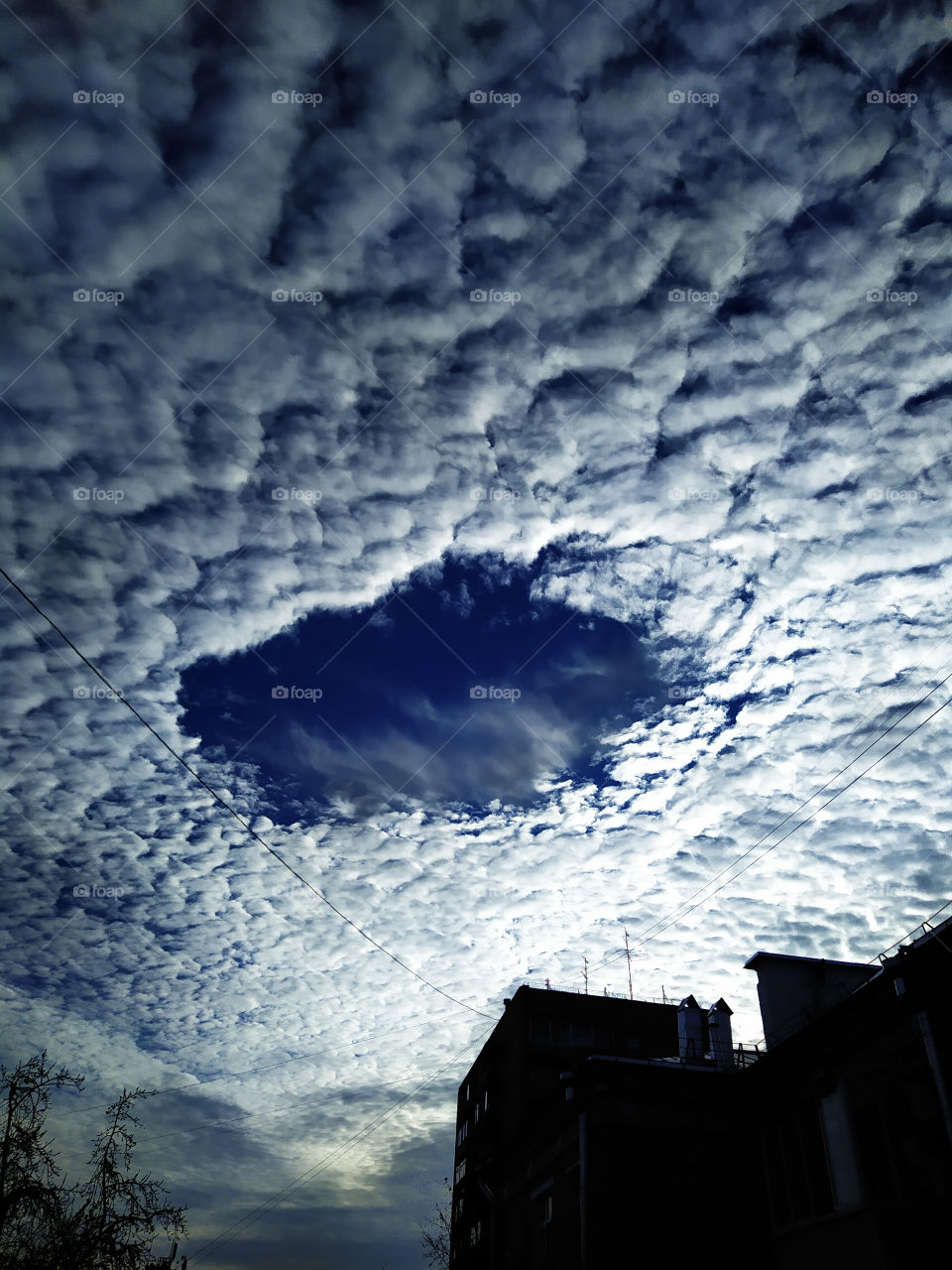 Clouds over the city.  An unusual kind of clouds in the form of a donut