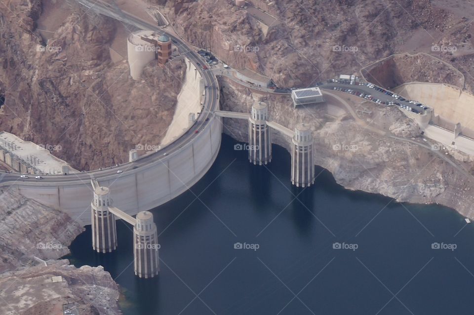 Hoover dam is also a roadway that joins Nevada and Arizona as is holds back the Colorado River in the Black Canyon. Aerial view.