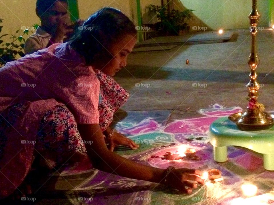 Girl lighting oil lamp