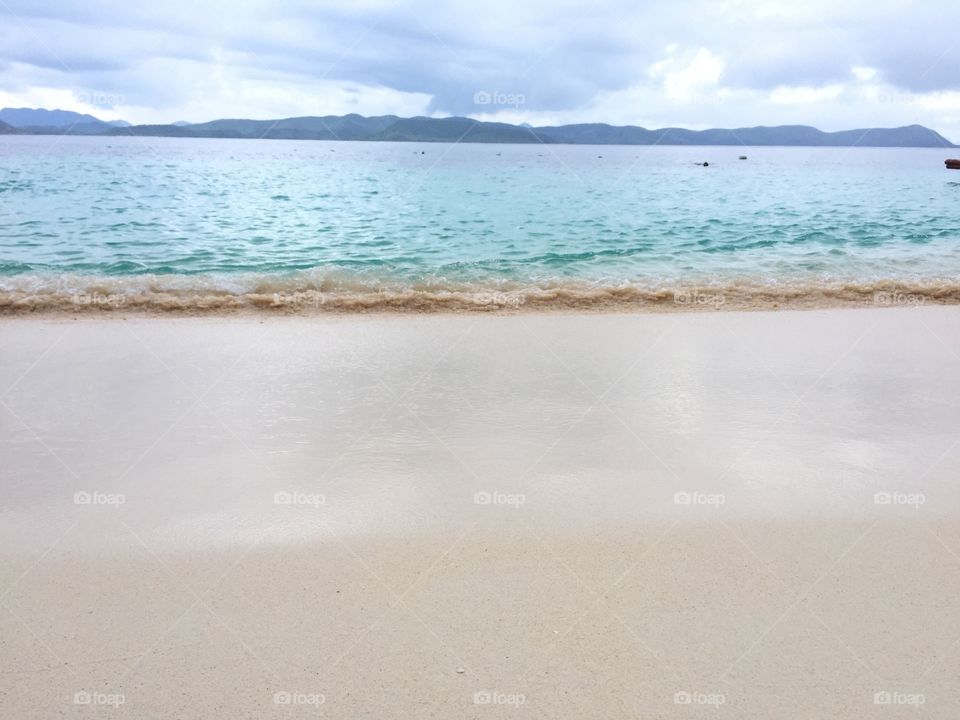 Waves in a white sand beach