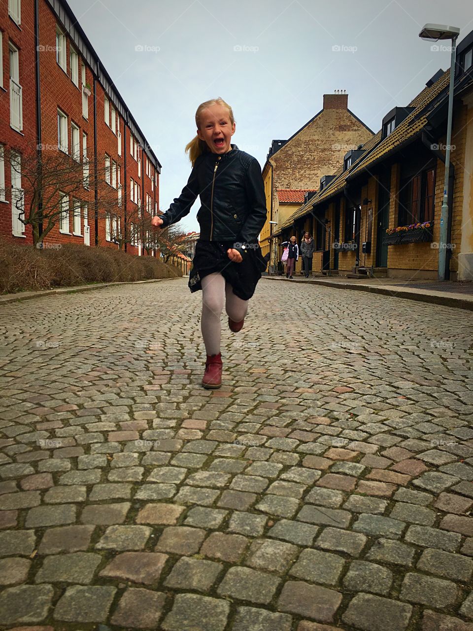 Girl running near buildings