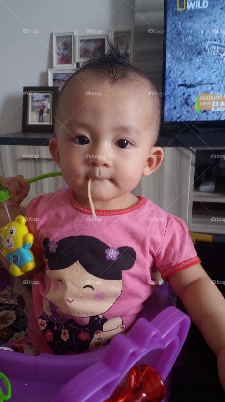 baby girl enjoying her pasta.