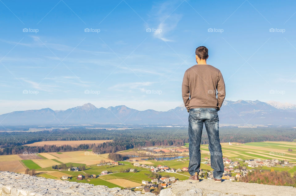 Young man peacefully enjoying view of European Alps