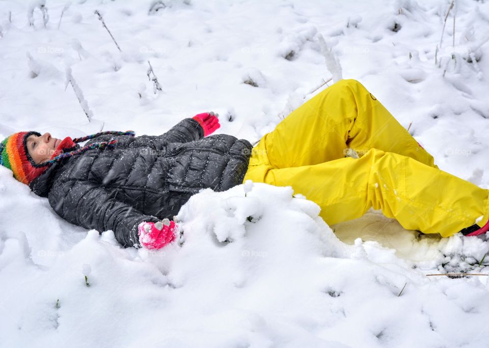 girl resting on the snow winter time