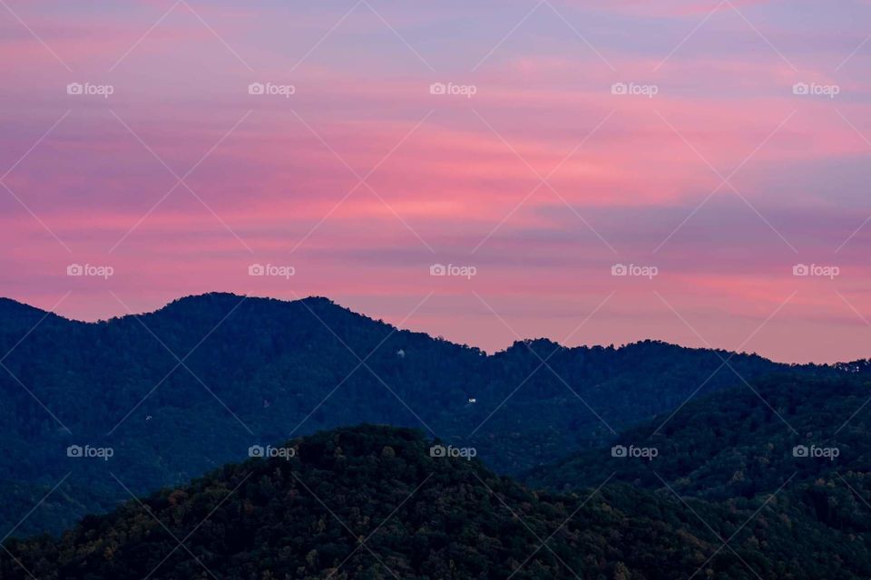 beautiful peaceful pink and blue sunset sky over the mountains in North Carolina USA