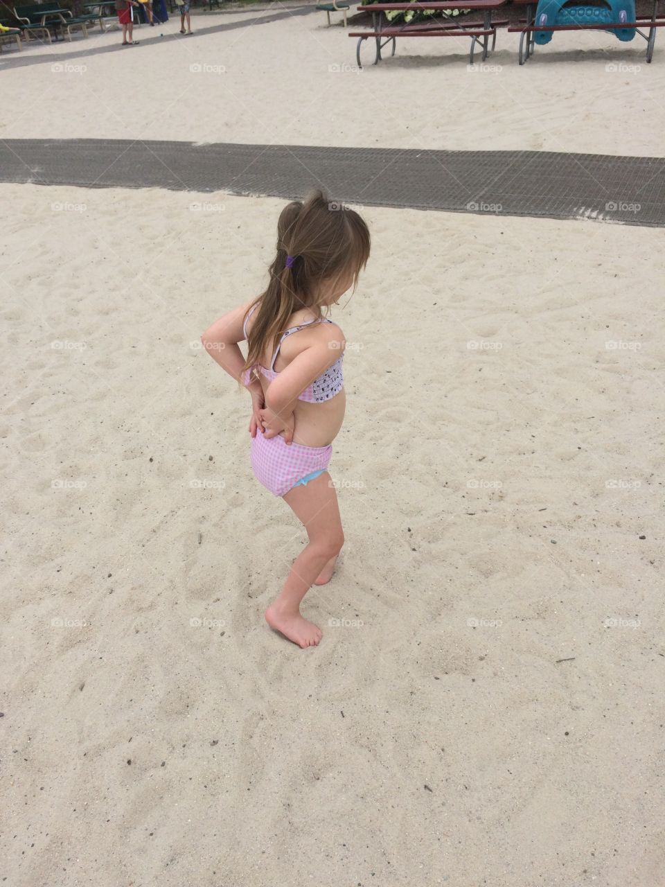 Little girl with Down syndrome on beach 