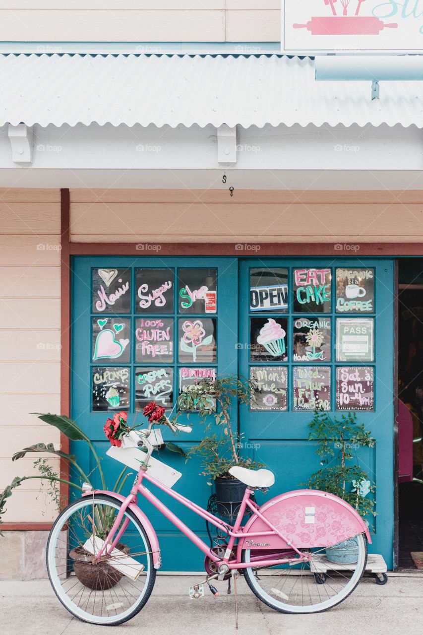 Beautiful Pink Bicycle Standing In Front Of A Shop