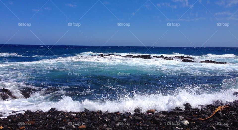 View of waves crashing on rocks at sea