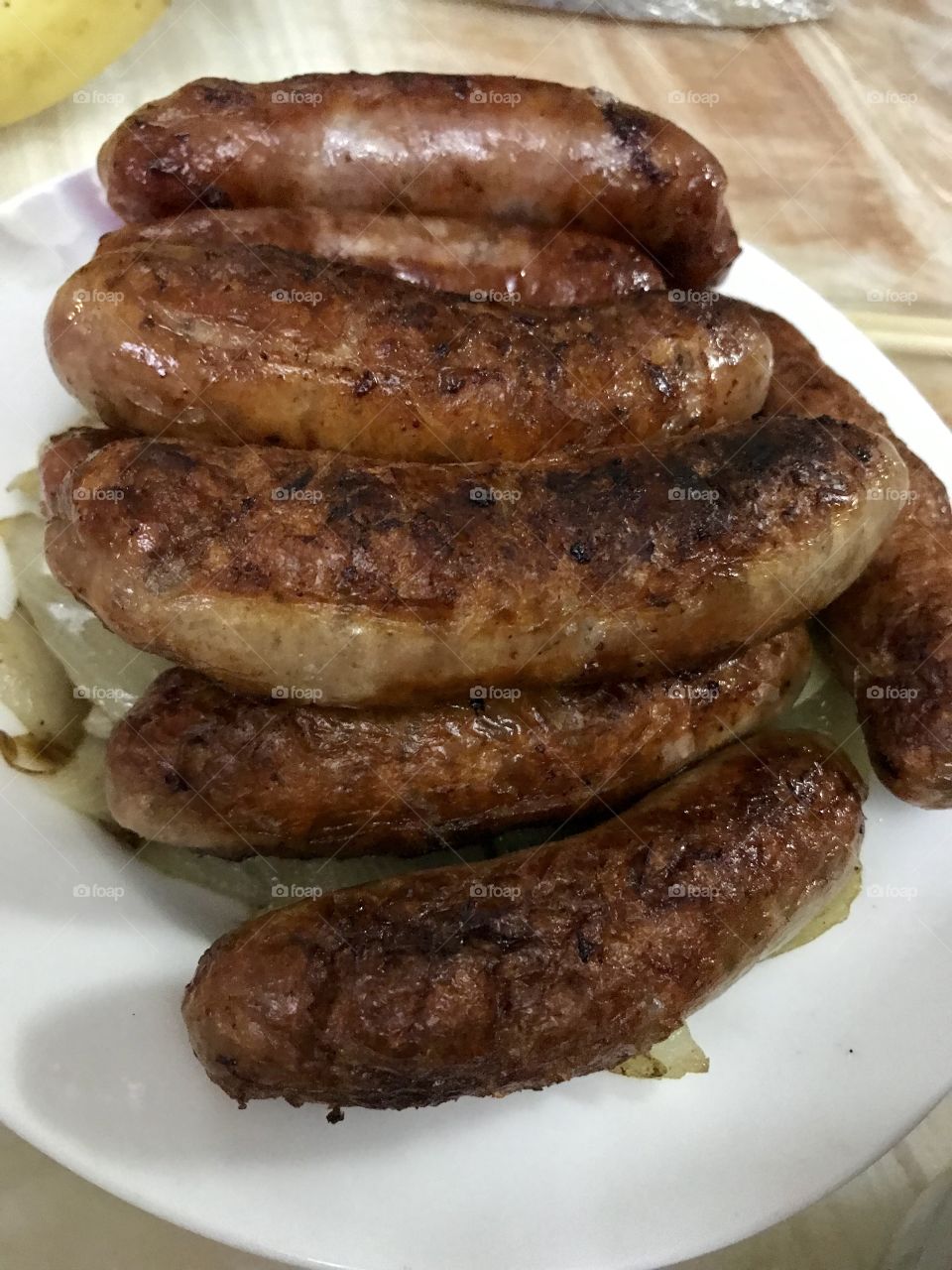 Grilled pan fried brown sausages on a plate