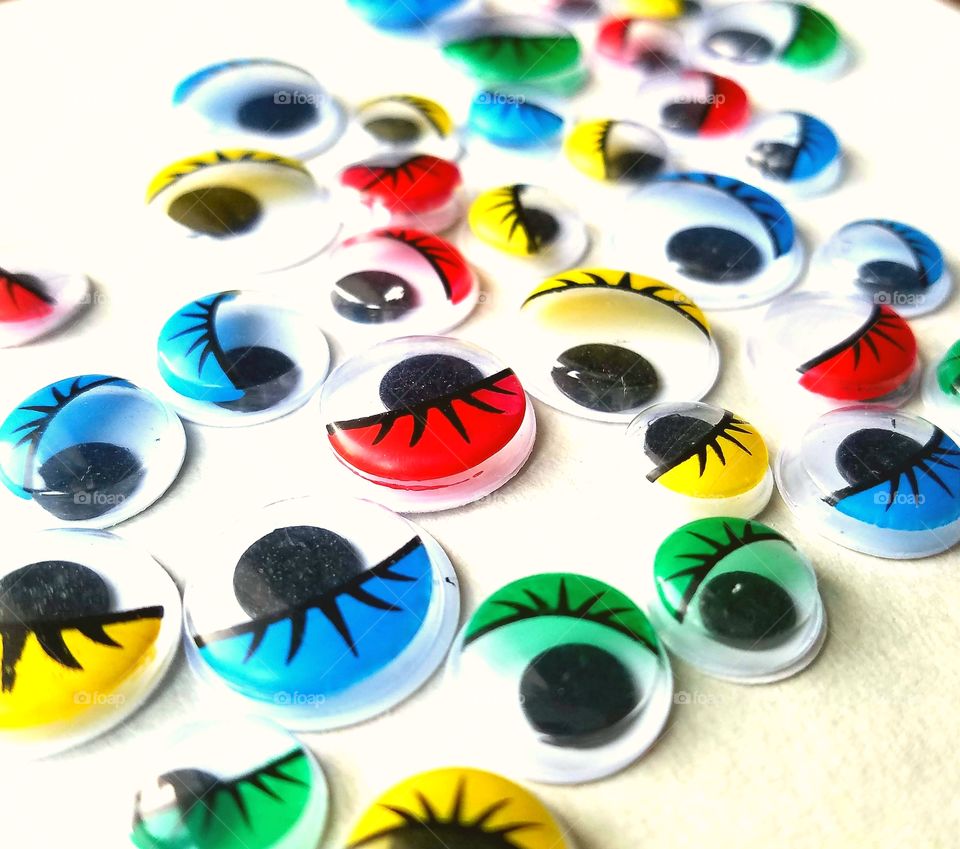 close up, many colorful googly eyes